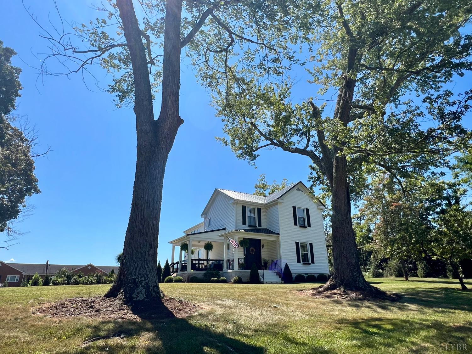 120 North Main Street Amherst, VA 24521 - Photo 50 of 62 a view of house with swimming pool and trees in the background