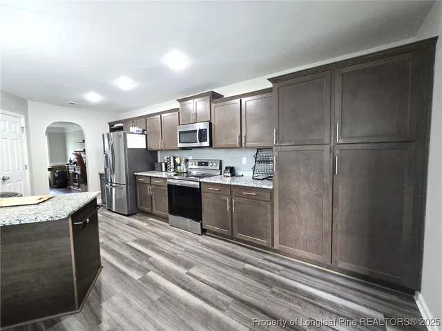 a kitchen with a refrigerator and a sink