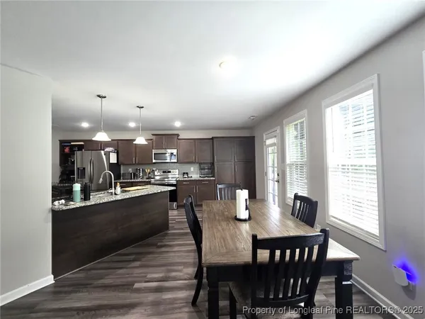 a dining room with furniture and wooden floor