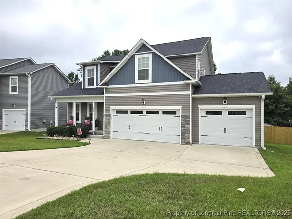 a front view of a house with a yard and garage