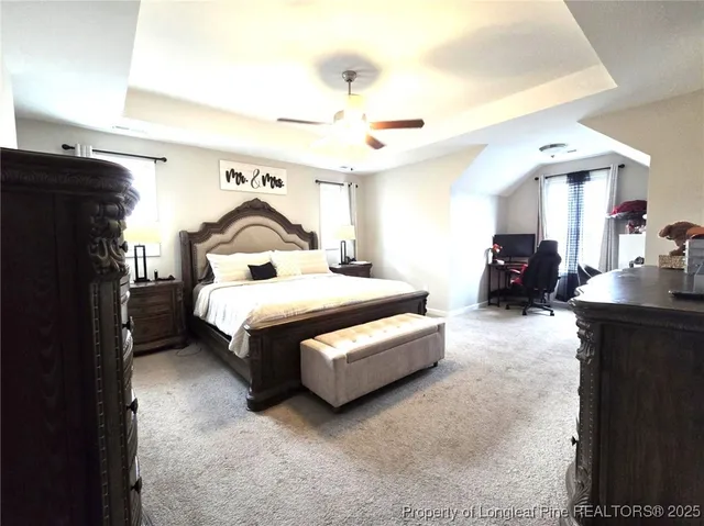 a bedroom with bed and a chandelier