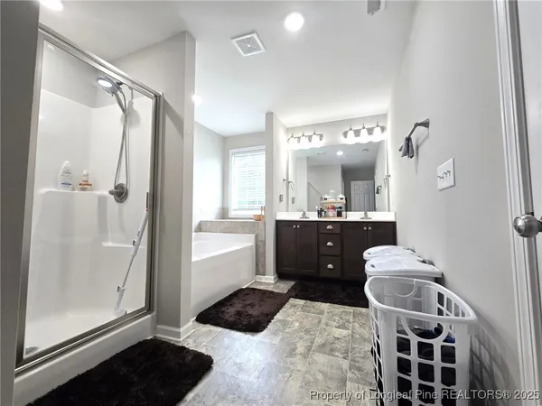 a bathroom with a tub sink and mirror