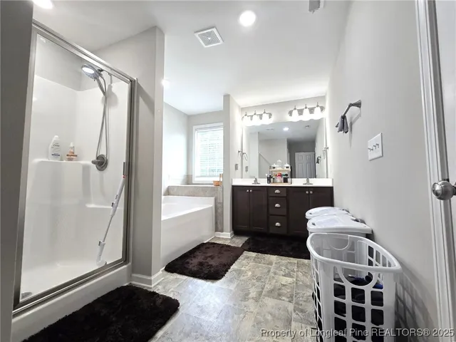 a bathroom with a tub sink and mirror