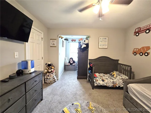 a bedroom with bed and a chandelier