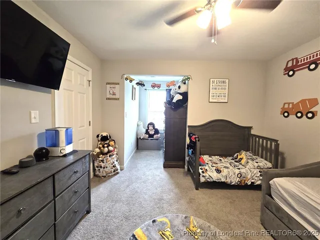 a bedroom with bed and a chandelier