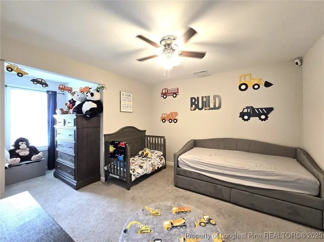 a bedroom with bed and a chandelier