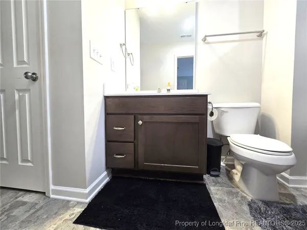 a bathroom with a toilet a sink and a mirror