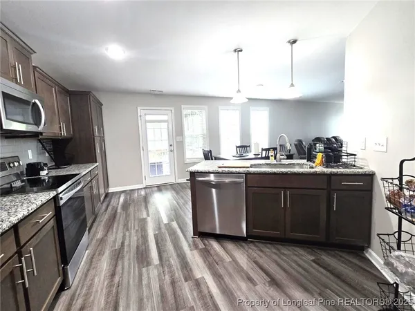 a kitchen with a sink a stove and cabinets
