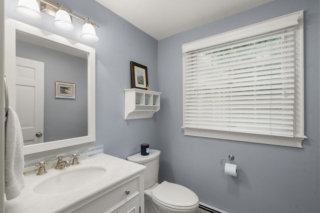 14 Harding Street Medfield, MA 02052 - Photo 14 of 33 a bathroom with a sink a toilet and a mirror