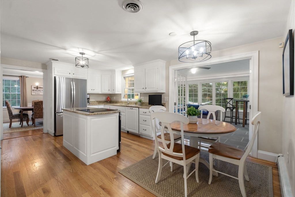 14 Harding Street Medfield, MA 02052 - Photo 6 of 33 a kitchen with a dining table chairs wooden floor and appliances