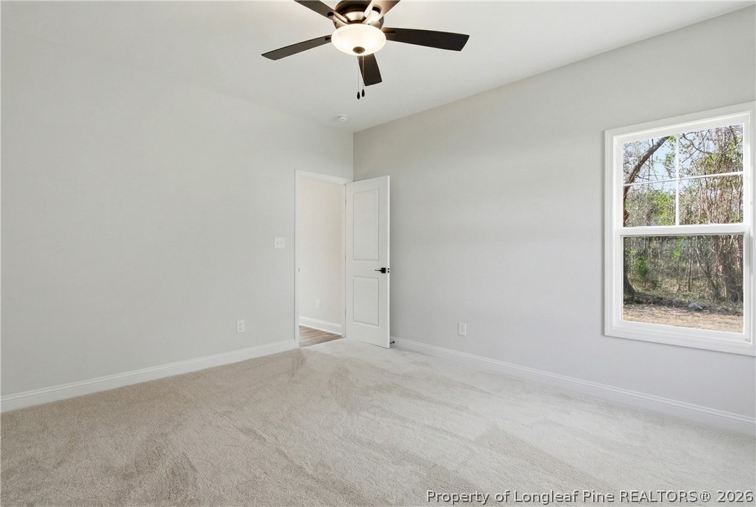 1523 McBryde Lake Road Raeford, NC 28376 - Photo 11 of 32 an empty room with windows and fan