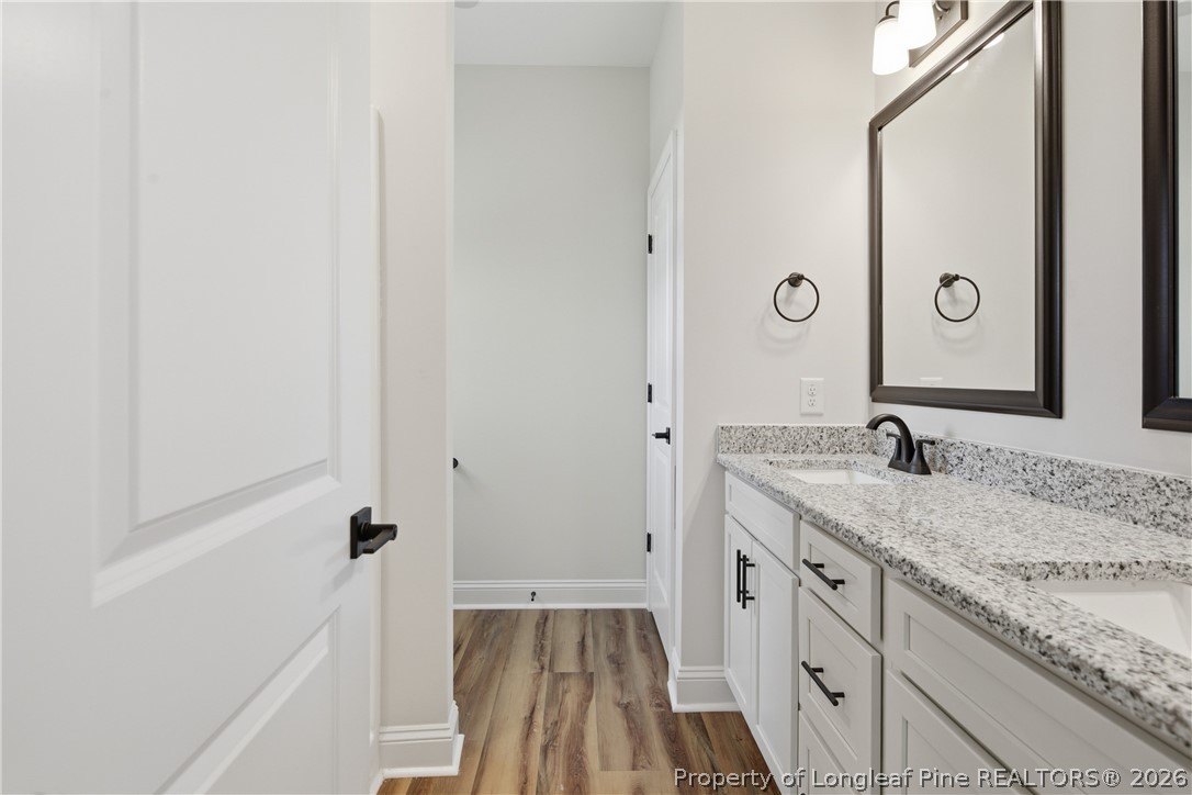1523 McBryde Lake Road Raeford, NC 28376 - Photo 13 of 32 a spacious bathroom with a granite countertop sink and a mirror