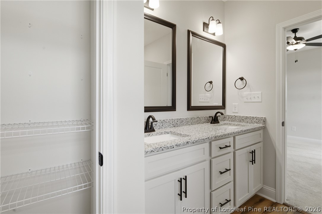 1523 McBryde Lake Road Raeford, NC 28376 - Photo 15 of 32 a bathroom with a granite countertop sink and a mirror