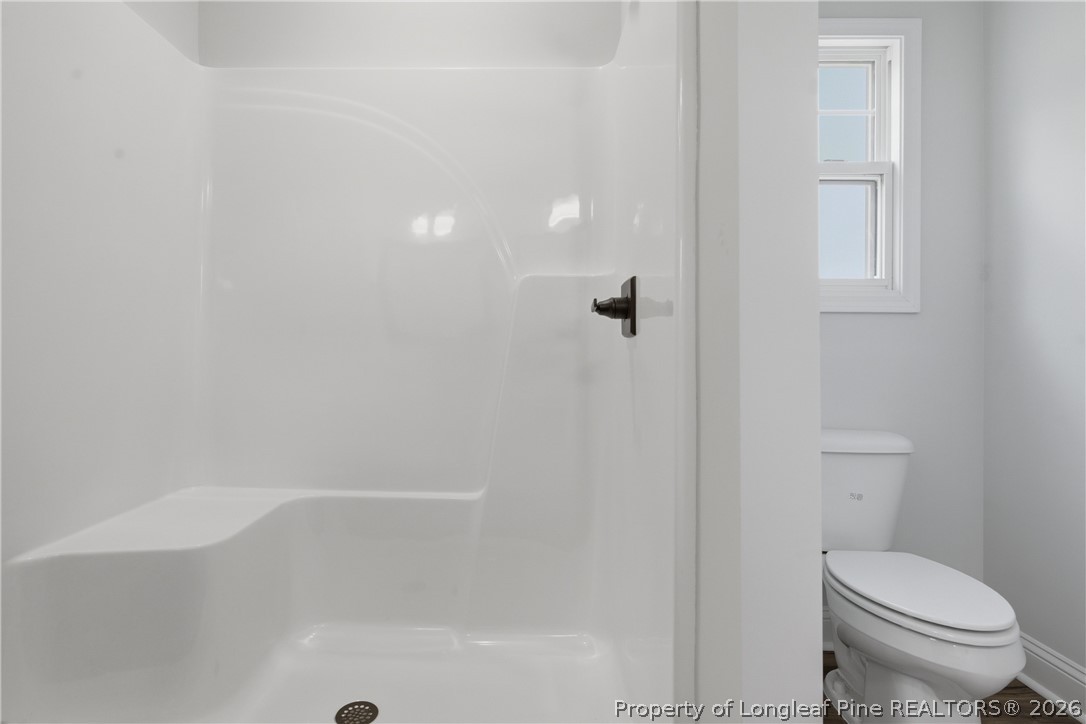 1523 McBryde Lake Road Raeford, NC 28376 - Photo 16 of 32 a bathroom with a toilet and a shower