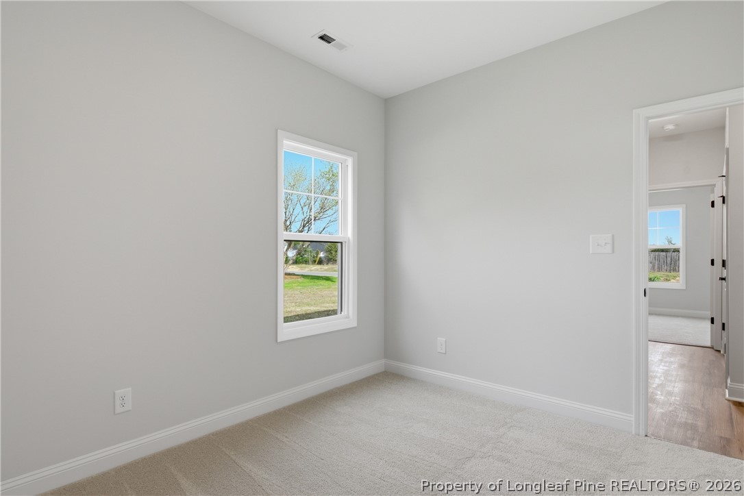 1523 McBryde Lake Road Raeford, NC 28376 - Photo 19 of 32 an empty room with windows and closet