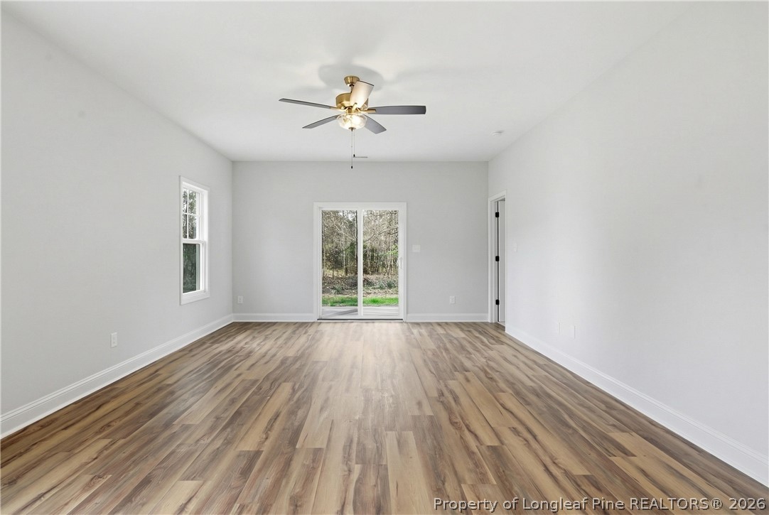 1523 McBryde Lake Road Raeford, NC 28376 - Photo 7 of 32 a view of an empty room with wooden floor and a window