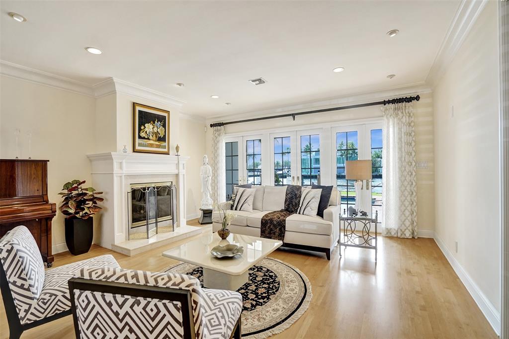 7 Saranac Road Sea Ranch Lakes, FL 33308 - Photo 15 of 93 a living room with furniture a fireplace and a flat screen tv