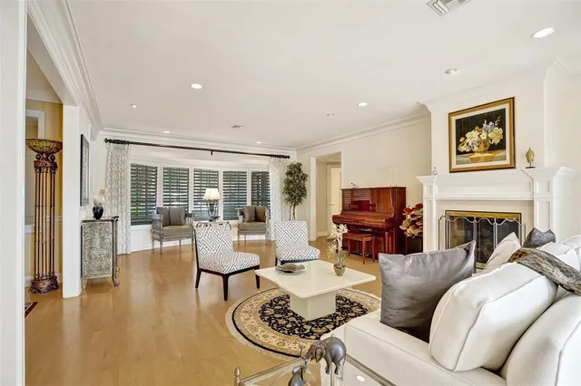 a living room with furniture ceiling fan and a large window