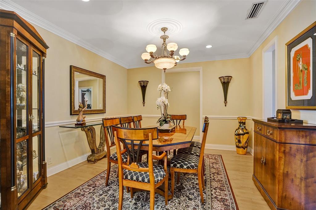 7 Saranac Road Sea Ranch Lakes, FL 33308 - Photo 20 of 93 a view of a dining room with furniture and a chandelier