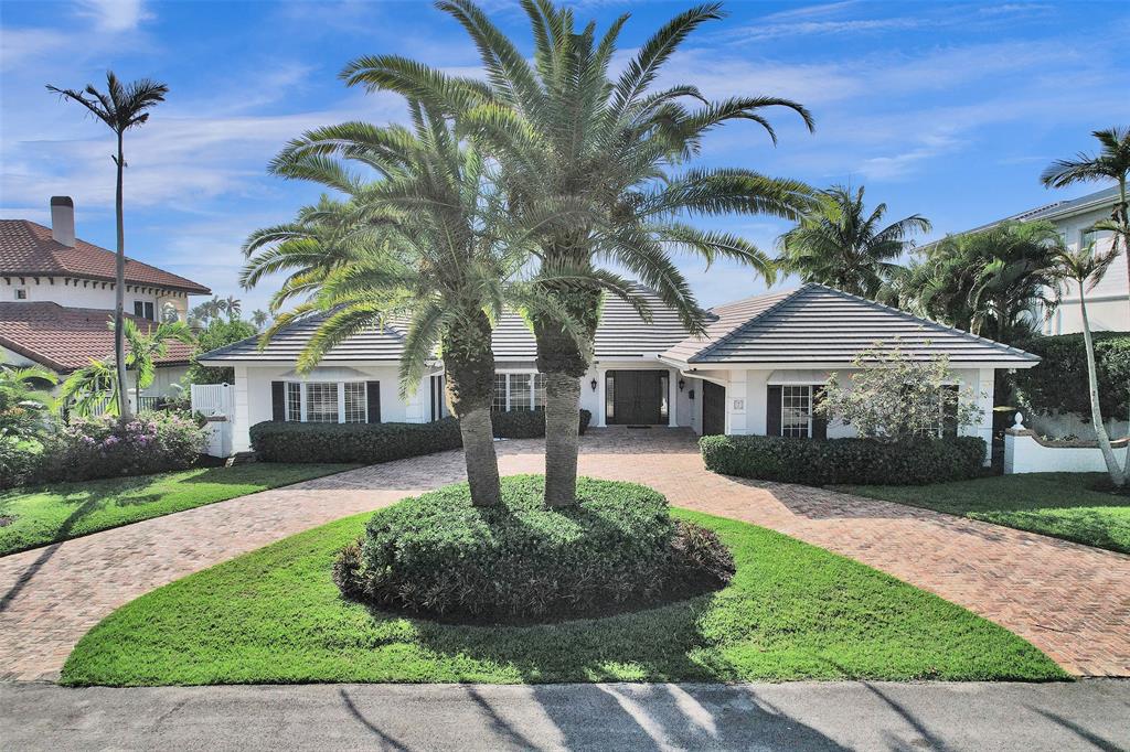 7 Saranac Road Sea Ranch Lakes, FL 33308 - Photo 2 of 93 a front view of a house with a garden and trees
