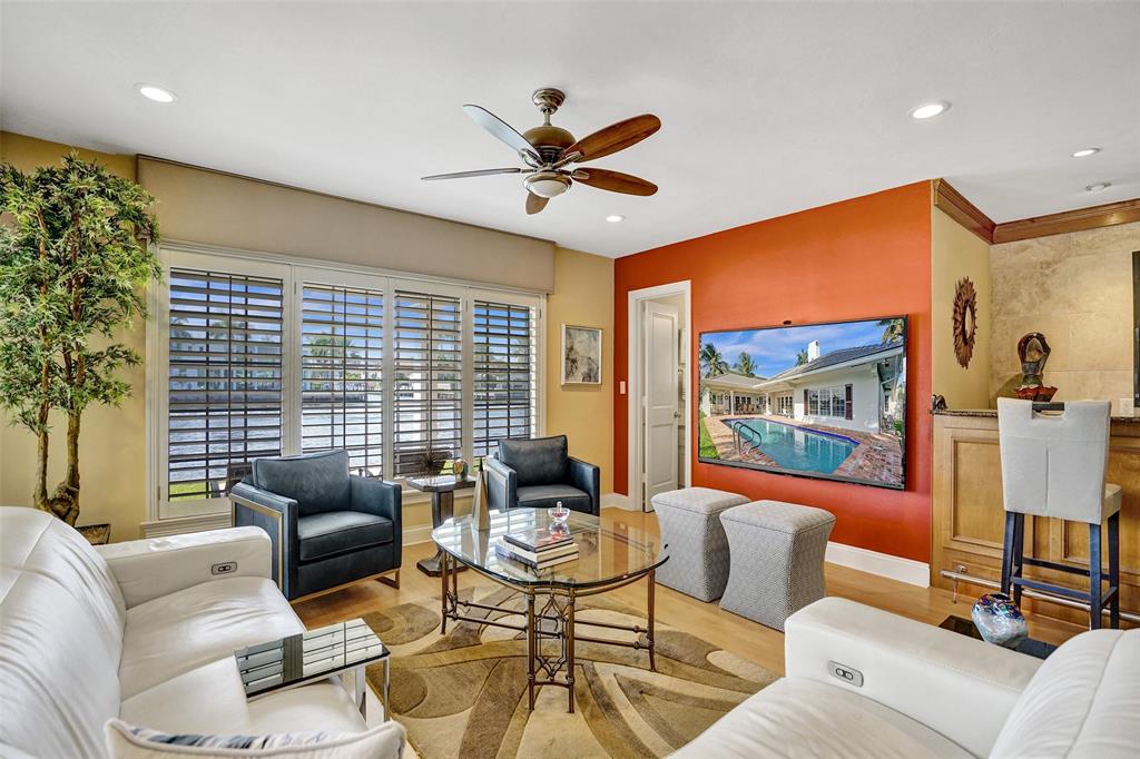 7 Saranac Road Sea Ranch Lakes, FL 33308 - Photo 23 of 93 a living room with furniture a ceiling fan and a window
