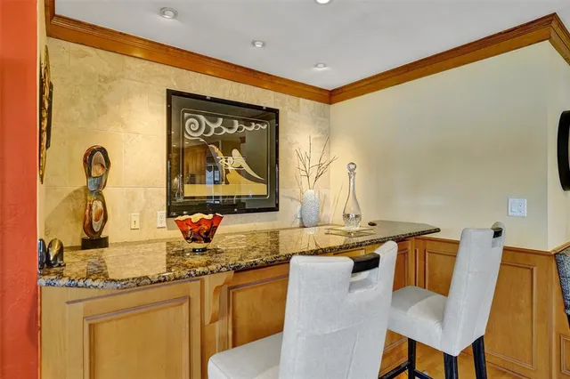 a spacious bedroom with a bed and a chandelier