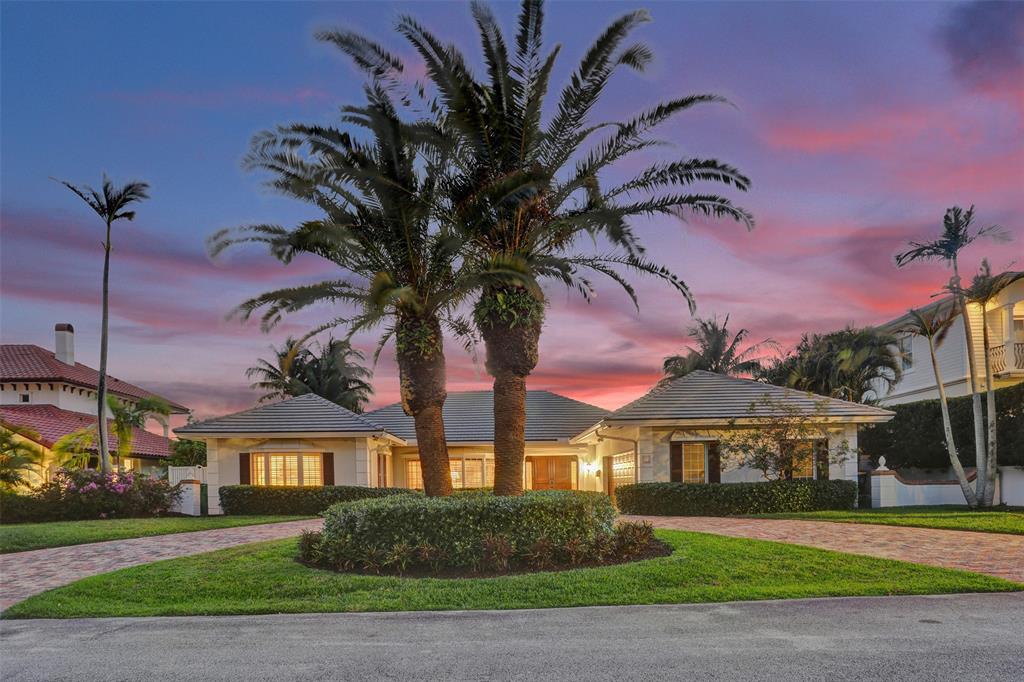 7 Saranac Road Sea Ranch Lakes, FL 33308 - Photo 3 of 93 a front view of a house with a garden and entryway