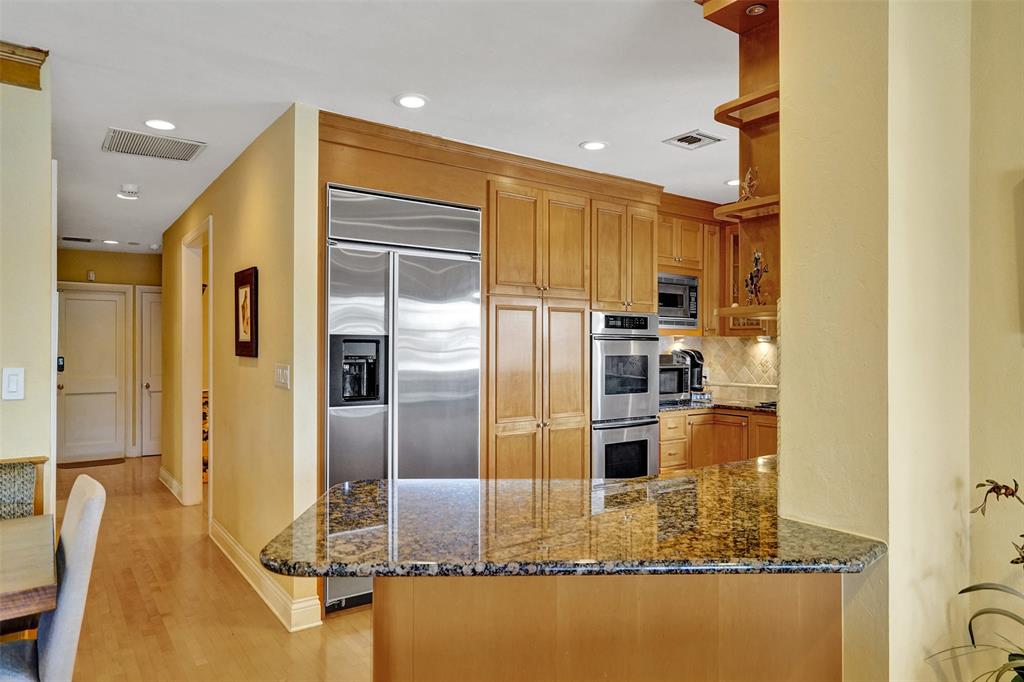 7 Saranac Road Sea Ranch Lakes, FL 33308 - Photo 35 of 93 a kitchen with kitchen island a counter top space cabinets stainless steel appliances and a counter top space