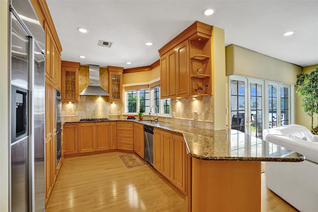 7 Saranac Road Sea Ranch Lakes, FL 33308 - Photo 38 of 93 a kitchen with stainless steel appliances granite countertop a sink and cabinets