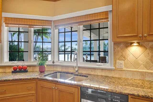 a palm tree sitting in front of a house with a yard