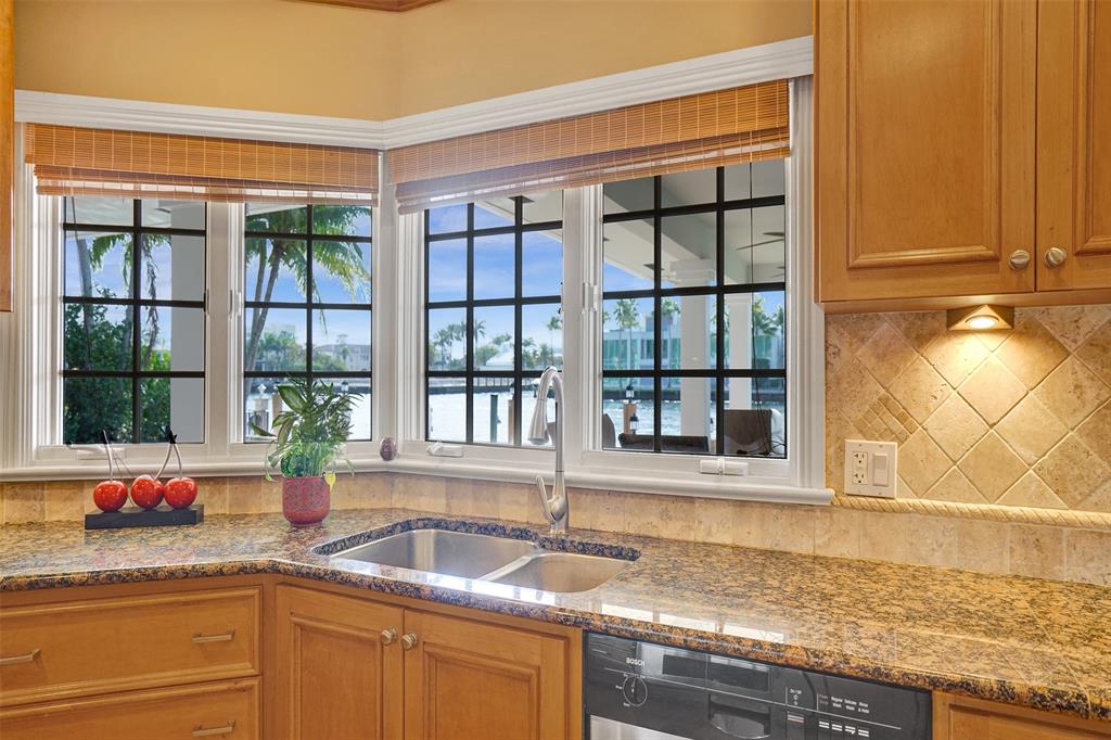 7 Saranac Road Sea Ranch Lakes, FL 33308 - Photo 41 of 93 a kitchen with granite countertop a sink and a window