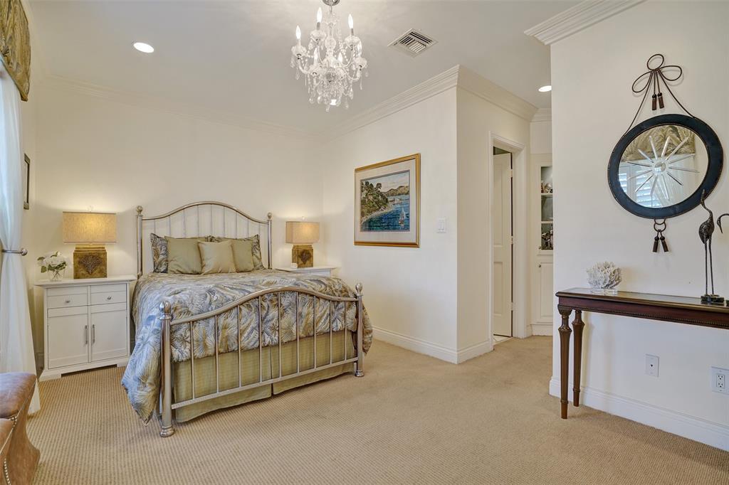 7 Saranac Road Sea Ranch Lakes, FL 33308 - Photo 53 of 93 a bedroom with a large bed and a chandelier
