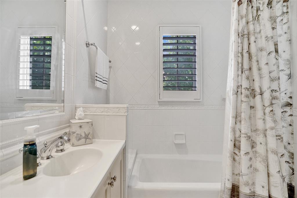7 Saranac Road Sea Ranch Lakes, FL 33308 - Photo 55 of 93 a bathroom with a bathtub sink vanity and a shower