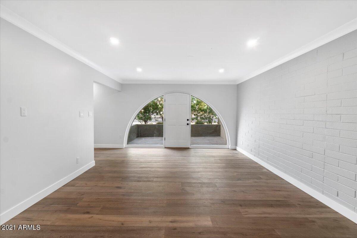 4041 East Camelback Road, Unit 2 Phoenix, AZ 85018 - Photo 22 of 25 an empty room with wooden floor and window