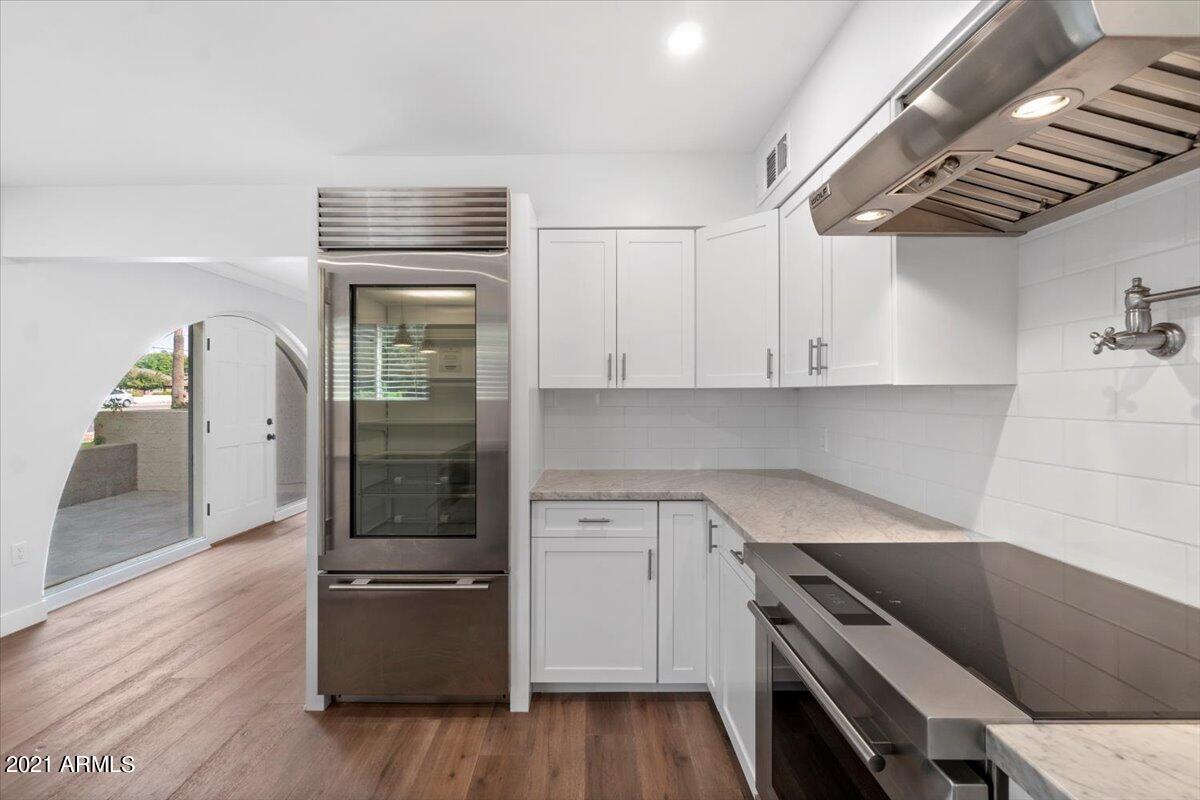 4041 East Camelback Road, Unit 2 Phoenix, AZ 85018 - Photo 8 of 25 a kitchen with wooden cabinets and a stove top oven
