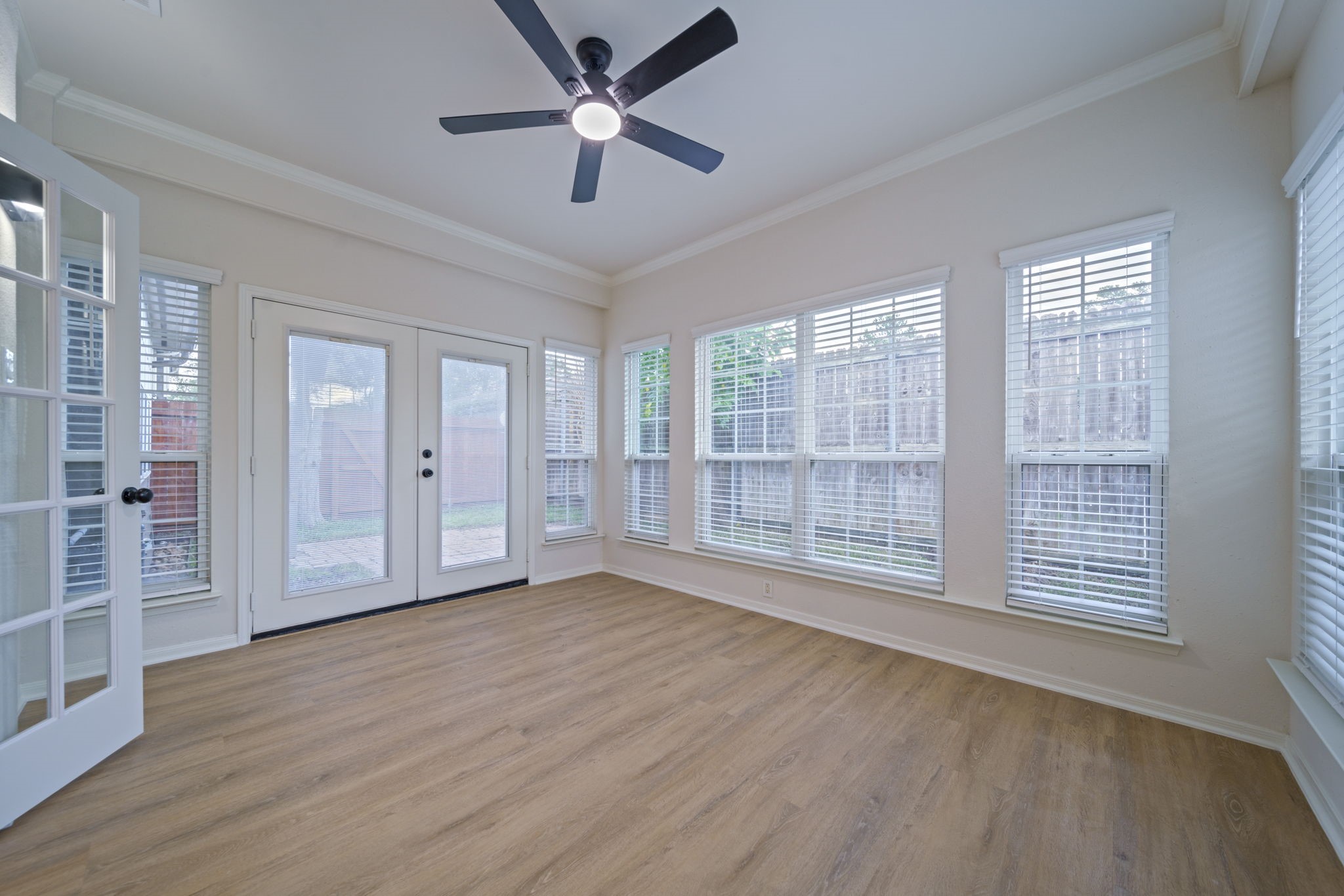14420 Walters Road, Unit 50 Houston, TX 77014 - Photo 11 of 23 an empty room with wooden floor and windows