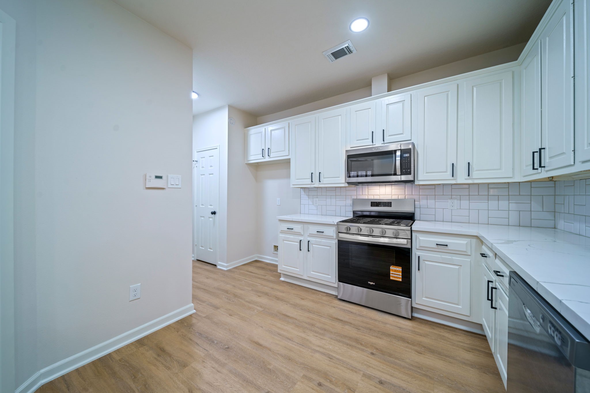 14420 Walters Road, Unit 50 Houston, TX 77014 - Photo 4 of 23 a kitchen with granite countertop white cabinets stainless steel appliances and a sink
