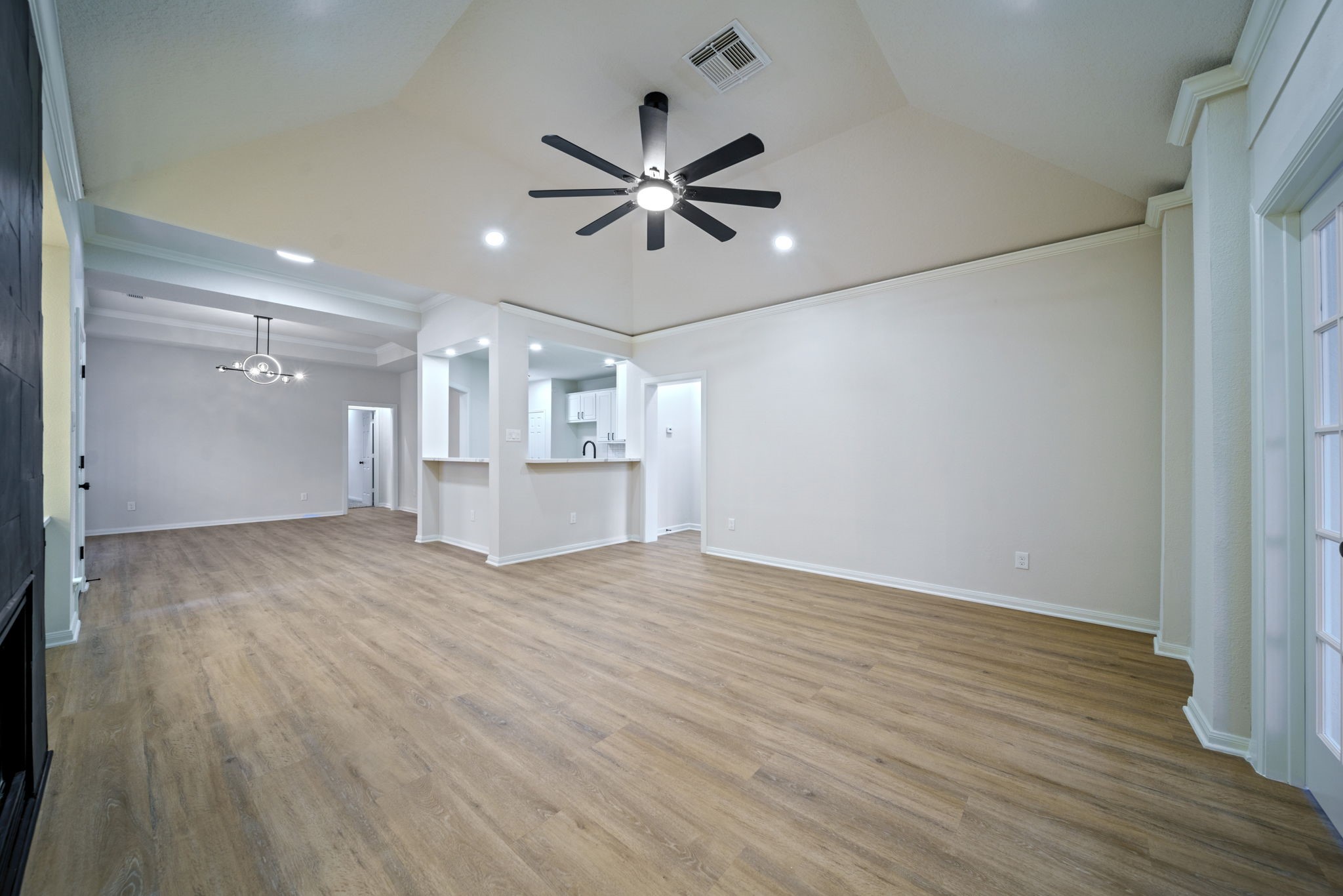 14420 Walters Road, Unit 50 Houston, TX 77014 - Photo 9 of 23 a view of a livingroom with wooden floor a ceiling fan and windows