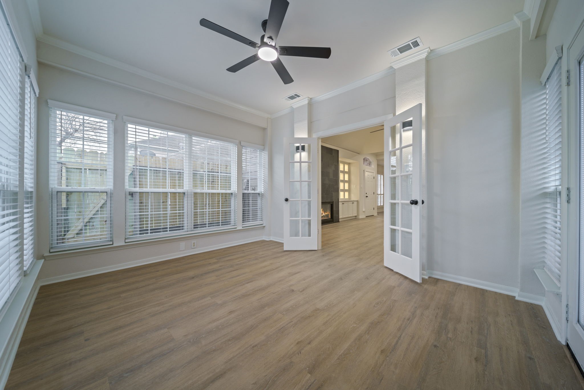 14420 Walters Road, Unit 50 Houston, TX 77014 - Photo 10 of 23 a view of wooden floor and a chandelier fan in a room