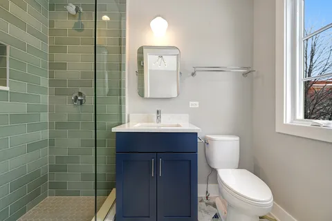a view of kitchen with sink and refrigerator