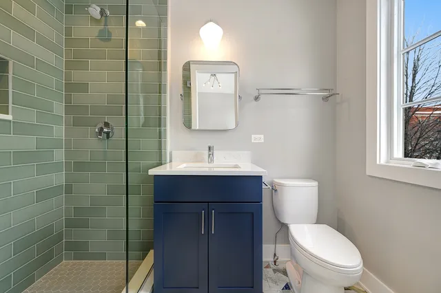 a view of kitchen with sink and refrigerator