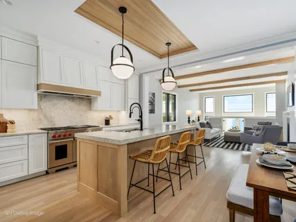 a kitchen with stainless steel appliances granite countertop a sink a stove and refrigerator