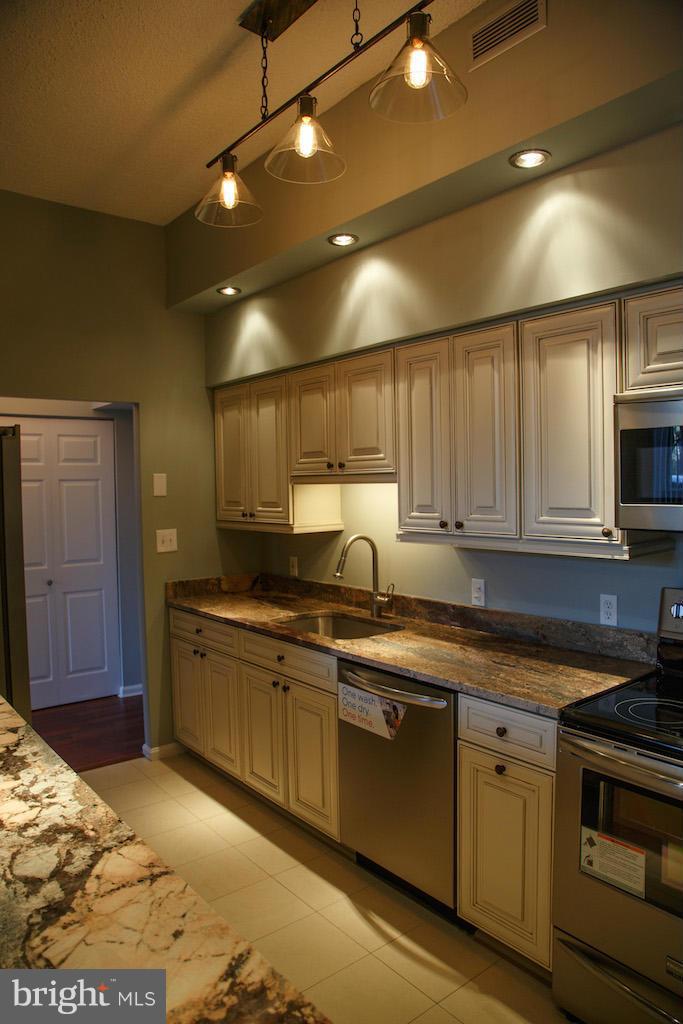 a kitchen with sink and cabinets