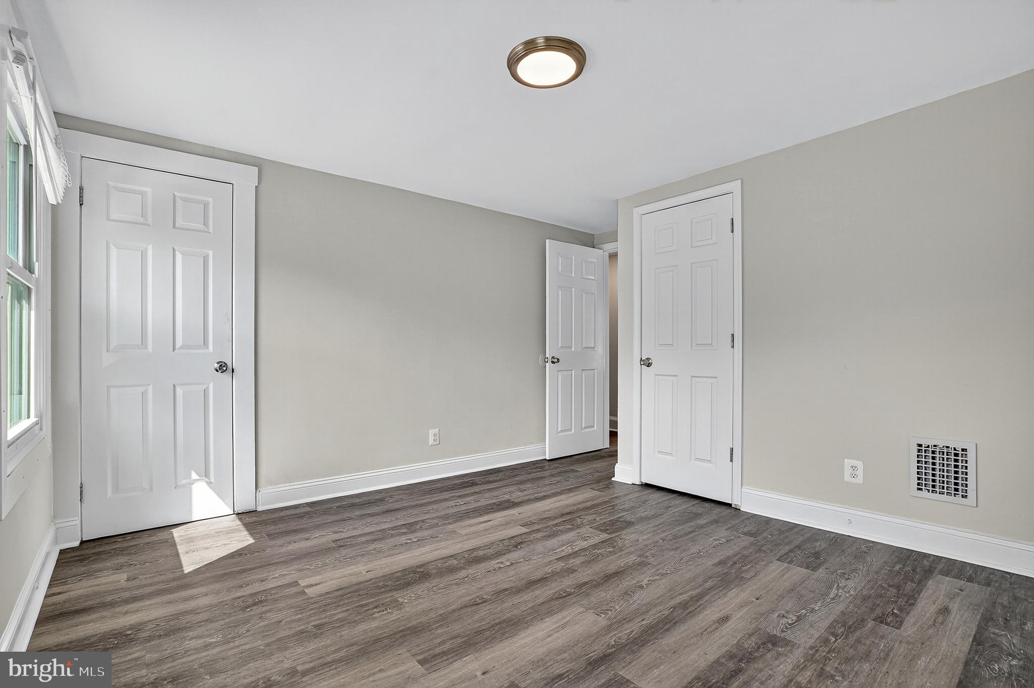 4203 Morrison Court Curtis Bay, MD 21226 - Photo 11 of 23 an empty room with wooden floor and windows