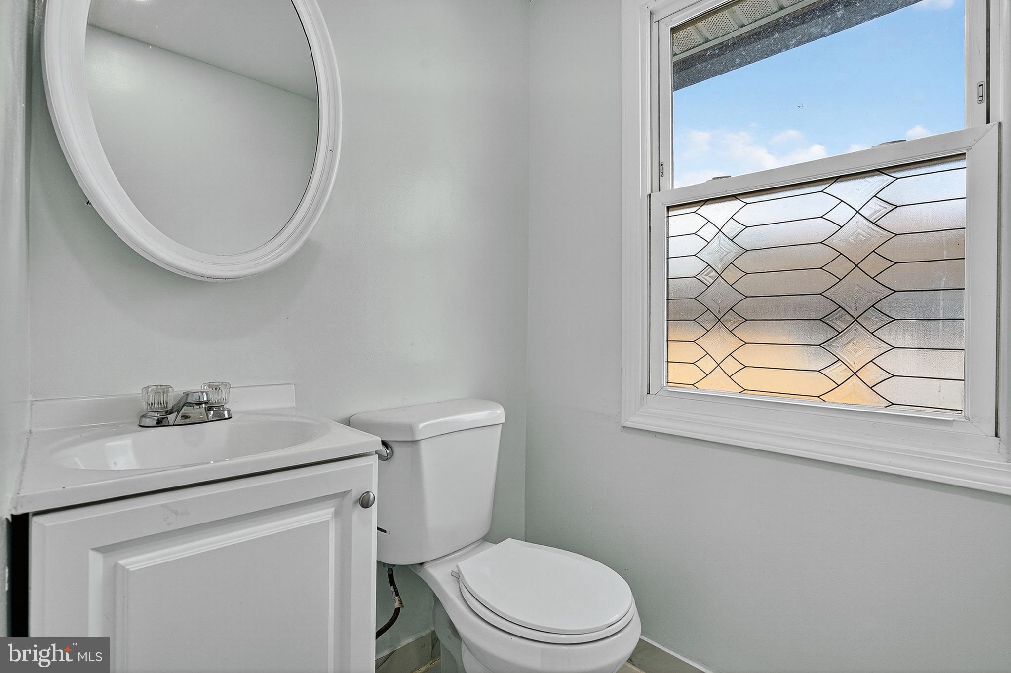 4203 Morrison Court Curtis Bay, MD 21226 - Photo 14 of 23 a white toilet sitting next to a bathroom sink