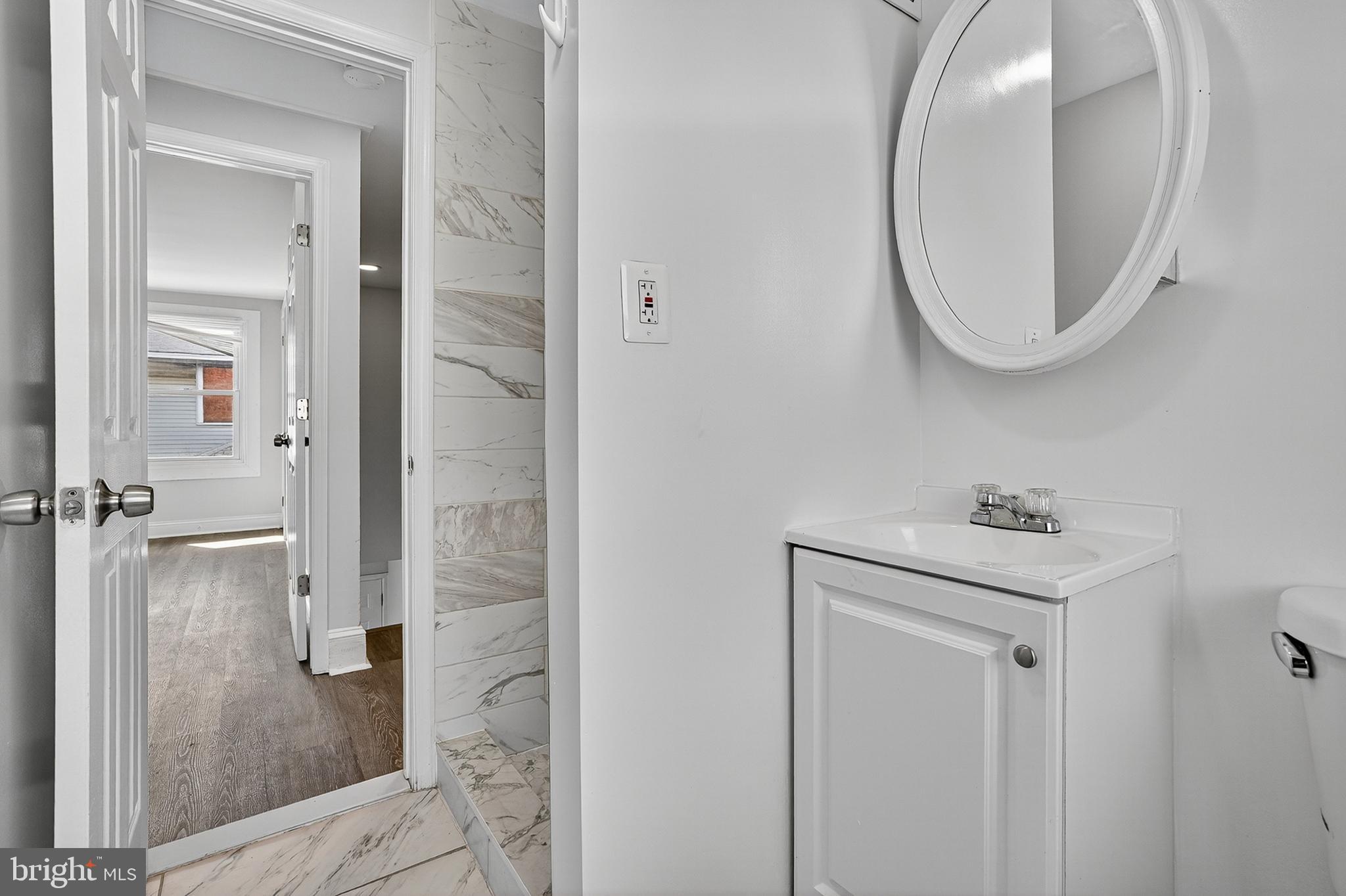 4203 Morrison Court Curtis Bay, MD 21226 - Photo 15 of 23 a bathroom with a mirror and a shower