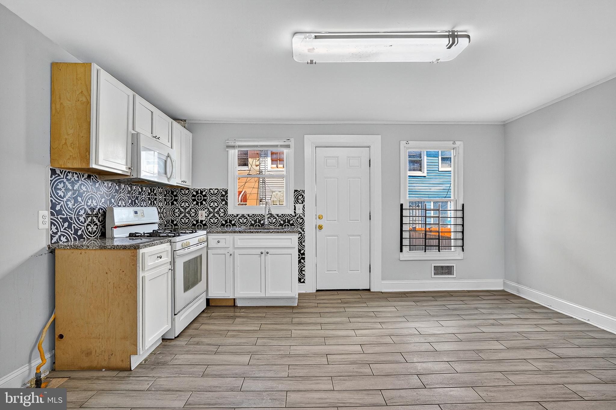 4203 Morrison Court Curtis Bay, MD 21226 - Photo 7 of 23 a kitchen with stainless steel appliances granite countertop a stove a sink and a refrigerator