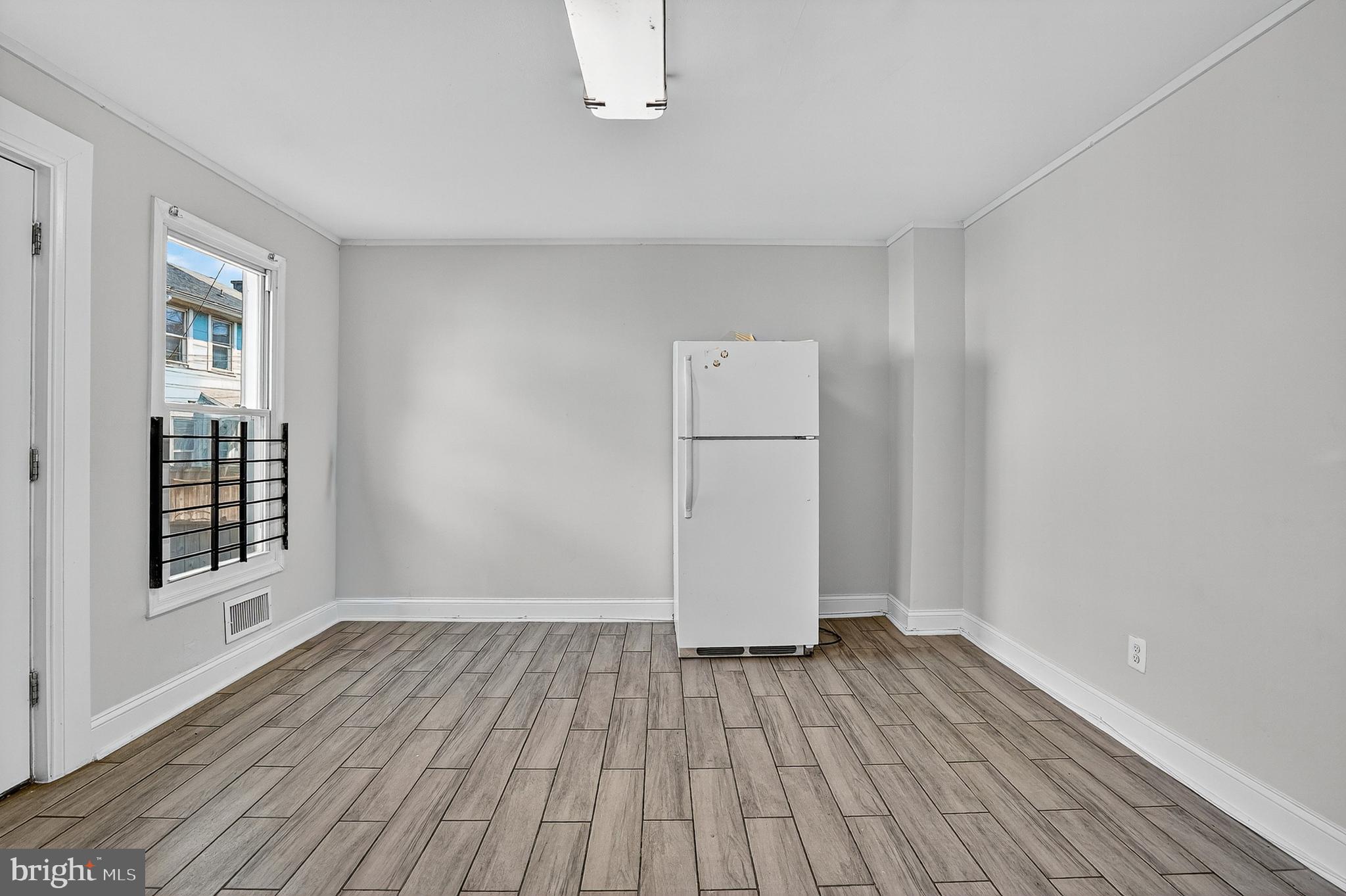 4203 Morrison Court Curtis Bay, MD 21226 - Photo 8 of 23 wooden floor in an empty room with a window