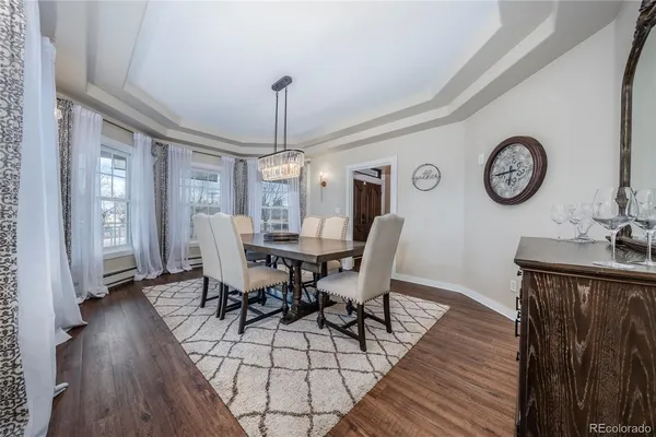 a view of a dining room with furniture wooden floor and a clock