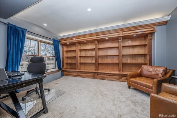 a livingroom with workspace and a window